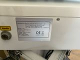 a label on the back of a machine that is sitting on a table