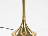 an image of a gold table lamp on a white background