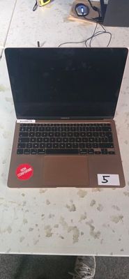 a laptop computer sitting on a table in a room