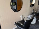 a photo of a salon room with chairs and mirrors