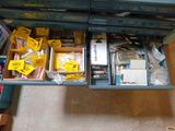a drawer full of assorted items on the floor