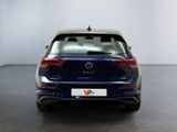 the back of a blue volkswagen v - cross parked in a white room