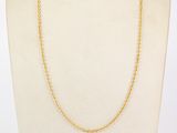 a gold chain necklace on a mannequin mannequin