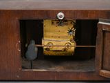 a clock that is sitting inside of a wooden box