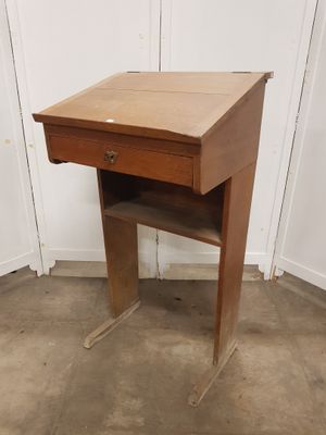 a small wooden desk with a drawer on top of it