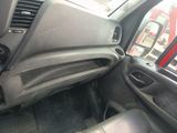 the interior of a car with the door open showing the dashboard