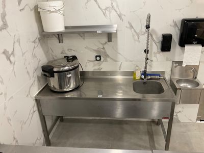 a kitchen with a sink and a pot on the counter