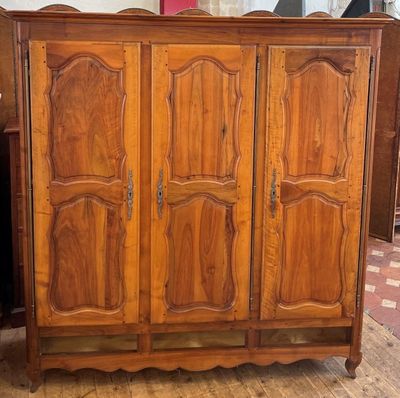 a wooden cabinet that is sitting on a wooden floor