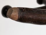 a close up of a wooden stick with black beads on it