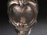 a silver object with a heart on it on a table