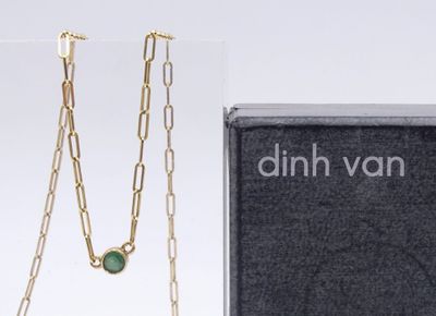 an image of a necklace with a green stone on it and a box