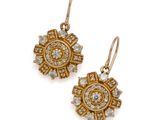 a pair of gold and diamond earrings