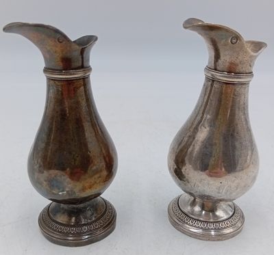 paire de vases anciens en métal argenté sur socle, sur fond blanc