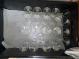 a black tray with a bunch of wine glasses in it