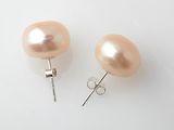 a pair of pink pearl earrings on a white surface