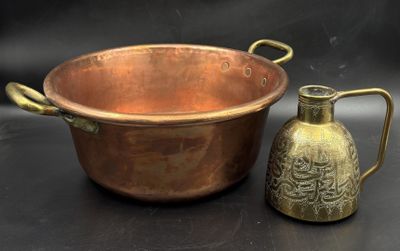 a copper pot and a brass jug on a black background