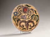 a plate with a design on it sitting on a stand
