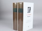 two books sitting on top of each other on a white surface