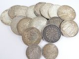 a pile of coins sitting on a white surface