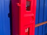 a red fire hydrant that is on the side of a building