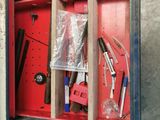 a red box with tools inside of it on the floor