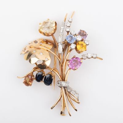 an image of a brooch with a bunch of different colored stones