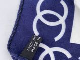 blue and white scarf with white circles and a black tag on it