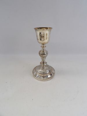 an image of a silver goblet sitting on a white surface