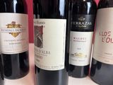several bottles of wine are lined up on a table