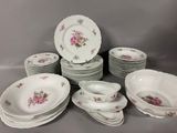 a lot of plates and bowls that are sitting on a table