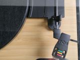 a picture of a turntable with a remote attached to it