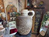 a large vase sitting on top of a table in a room