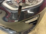 a close up of a car ' s headlight with a remote control