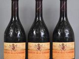 three bottles of wine are lined up on a glass table