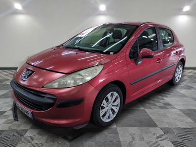 a red car parked in a garage with a checkered floor