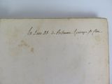 an old book with writing on it sitting on a table