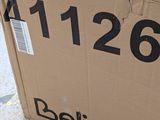 a cardboard box with a sign on it sitting on the sidewalk