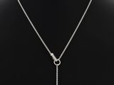 a necklace with a heart charm on a mannequin mannequin