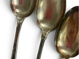three spoons that are sitting next to each other