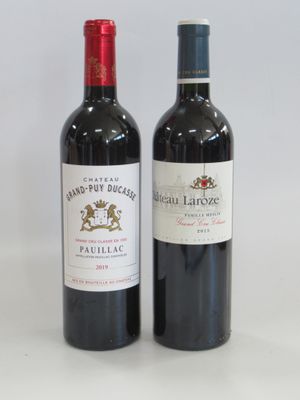 two bottles of wine sitting next to each other on a table