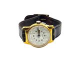 a watch that is sitting on top of a black leather strap