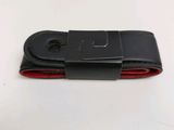 a black leather wallet with a red stripe on it