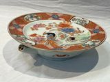 a plate with a bird on it sitting on a table