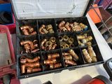 a box full of copper pipes and fittings on a table