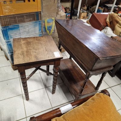 two tables that are sitting on the floor in the room