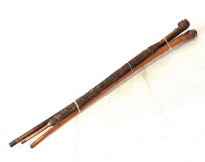 pair of wooden chopsticks on a white surface