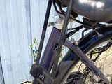 a purple bicycle parked next to a blue building