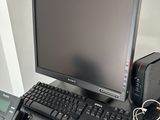 a desktop computer and a telephone on a desk