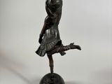 bronze statue of a ballerina on a pedestal with a white background