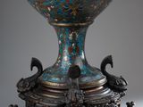 an image of a blue and gold vase on a stand